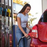 Young,Woman,Refueling,Car,At,Self,Service,Gas,Station