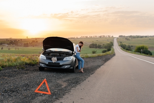 A,Frustrated,Young,Girl,Stands,Near,A,Broken-down,Car,In