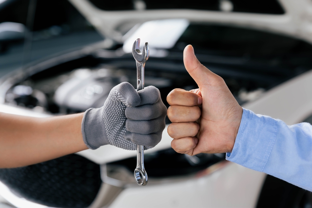 Mechanics,Is,Holding,A,Spanner,While,The,Other,Is,Showing